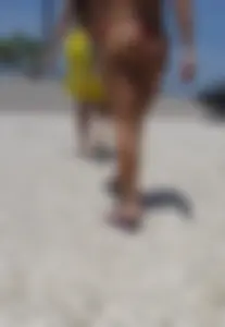 Big booty babe walking by the beach in thong