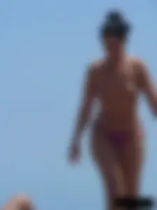 Purple thong topless lady on the beach gets oiled up by her husband