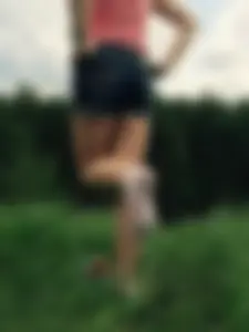 Girl in Shorts Standing in a Field Showing her White Sock