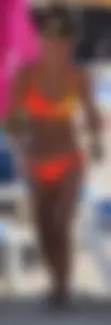Blonde teen on the beach in orange bikini