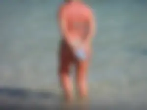 Blonde milf on the beach in her bikini