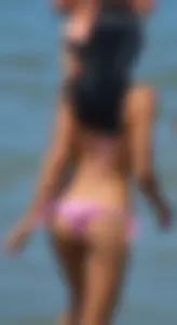 Little brunette ass in a pink bikini at the beach