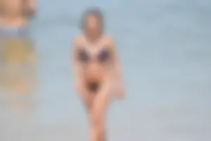 Blue bikini girl on the beach with a great ass and a little pussy lips slips