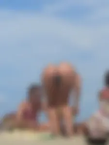 Sexy lady on the beach in a blue thong bikini