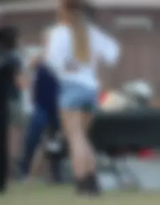 Hippie type dressed girl in denim shorts with a nice ass