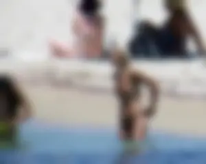 Small boobed topless milf on the beach