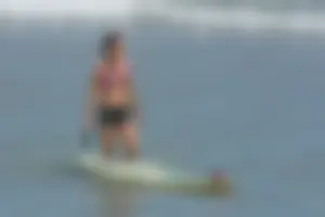 Candid girls surfing on the beach
