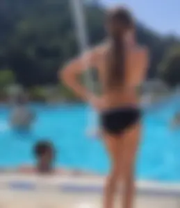 Skinny Teen in a Swimsuit Standing by the Pool