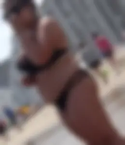Thick beach girl in black bikini with big ass and tits
