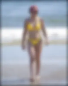 Sexy tattooed beach brunette with a great ass in yellow thong bikini