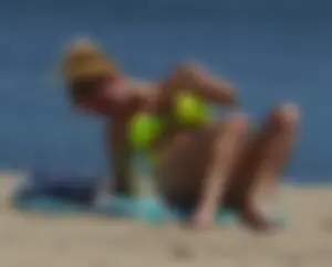 Sexy ass blonde milf on the beach in a thong with cameltoe and bending over