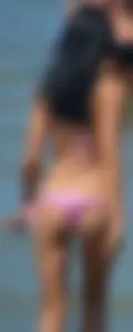Little brunette ass in a pink bikini at the beach