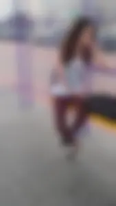 Cute skinny candid teen sitting at the bus station street photos
