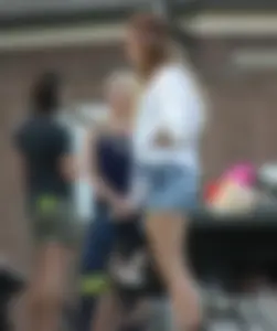 Hippie type dressed girl in denim shorts with a nice ass