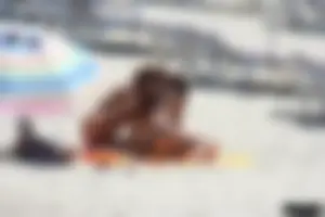Topless milf and her topless daughter on the beach