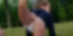 Three sexy girls in bikinis exercising at the park