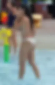 Sexy brunette lady with nice tits at the pool in a semi thong bikini