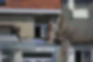 Neighbor on rooftop tanning in bikinis