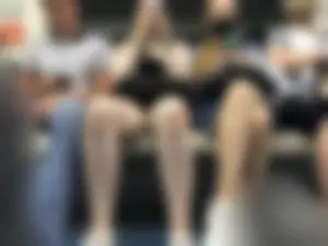 Tall Girl in Denim Mini Shorts and Sneakers With Long Pale Legs in a Subway Train