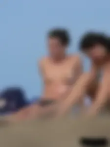 Sexy babe with a nice body topless and in a thong on the beach