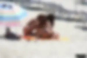 Topless milf and her topless daughter on the beach