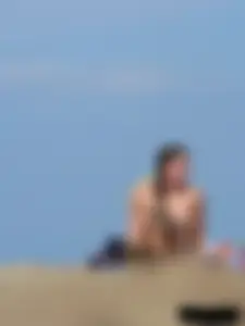 Sexy babe with a nice body topless and in a thong on the beach