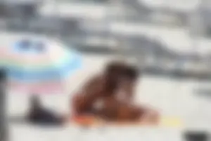 Topless milf and her topless daughter on the beach
