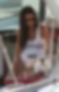 Bikini babe on a boat with a wet see through white shirt showing her tits