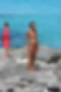 Older lady on a nude beach showing her body