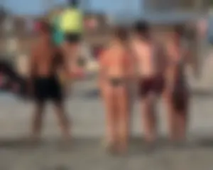 Thick white girls ass in a black thong bikini at the beach
