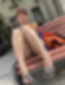 Mature Redhead in a Dress Flashing Panties While Sitting on a Street Bench