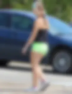 Blonde girl in glasses with a thick booty in green shorts