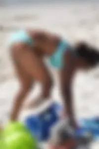 Tanned brunette girl on the beach in a bikini