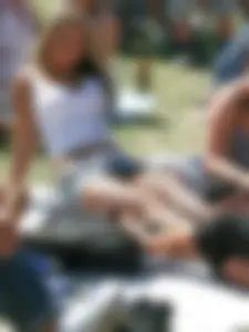 Busty Candid Girl in a Top, Jean Mini-Skirt And Fishnet Pantyhose Sitting on the Ground in the Park, Her Panties Flashing