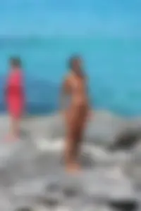 Older lady on a nude beach showing her body