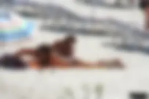 Topless milf and her topless daughter on the beach