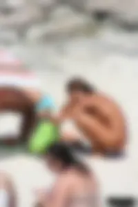 Older lady on a nude beach showing her body