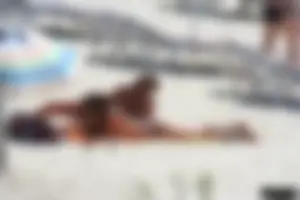 Topless milf and her topless daughter on the beach