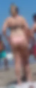 Chunky beach blonde babe in a pink thong bikini