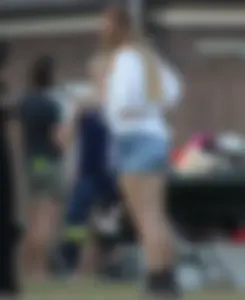 Hippie type dressed girl in denim shorts with a nice ass