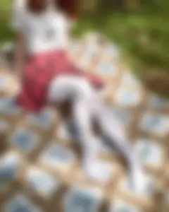 Teen in Chequered Skirt, Blouse and White Pantyhose Sitting on the Blanket in the Woods