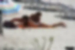 Topless milf and her topless daughter on the beach
