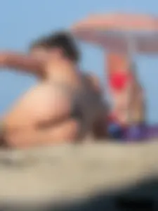 Sexy babe with a nice body topless and in a thong on the beach