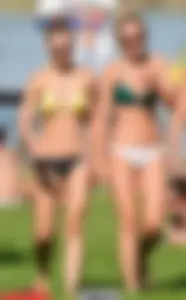 Sexy blonde girl in the park playing volleyball in her skimpy bikini