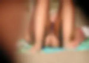 Topless girl on the beach showing some pussy lips in her little thong