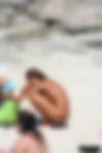 Older lady on a nude beach showing her body