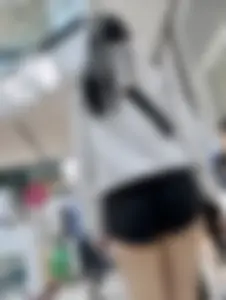 Asian girl in tight black shorts at the mall