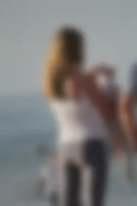 Skinny blonde on the beach in tight grey leggings