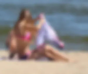 Two sexy beach teens in bikinis, one thick and one skinny with big boobs