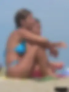 Sexy lady on the beach in a blue thong bikini